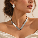 Conjunto plateado de collar geométrico y aros texturizados